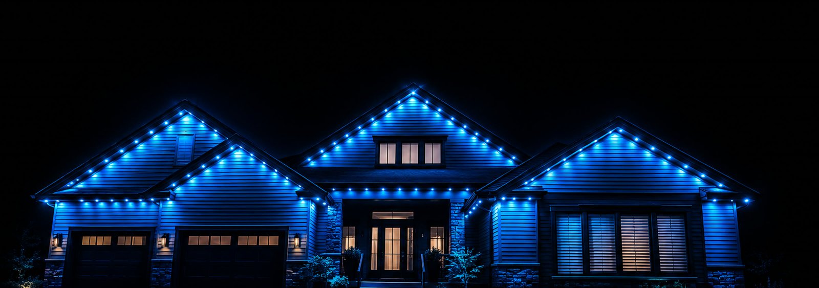 A home with a permanent Govee lighting system glowing blue along its roofline at night